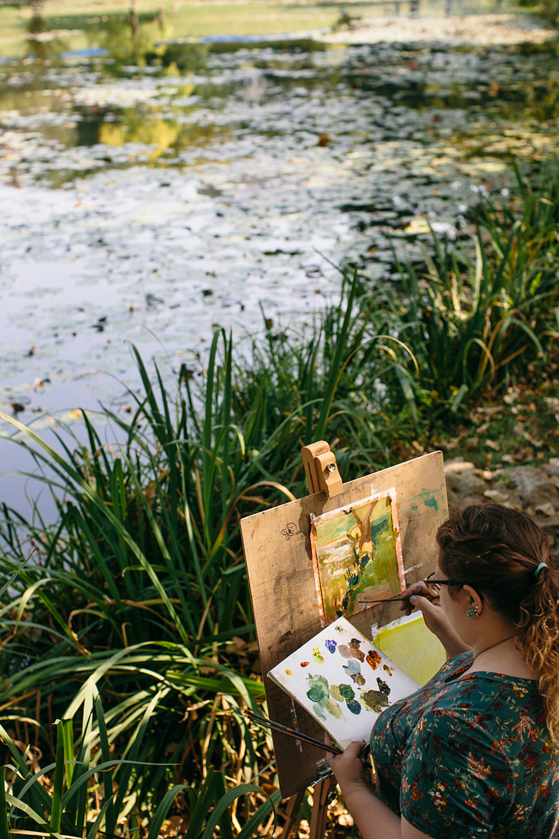 A student paints outside