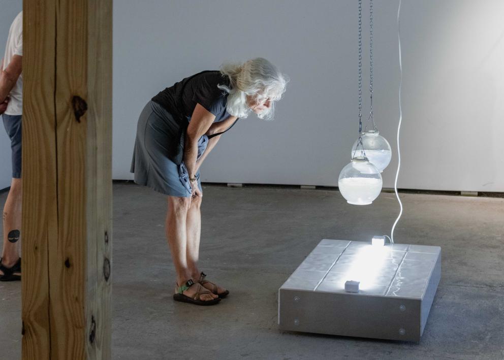 Gallery goer looking at sculpture