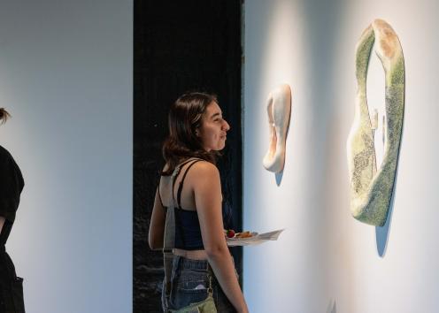 Gallery goer looking at art