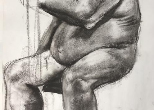 An unfinished charcoal drawing of a seated nude figure