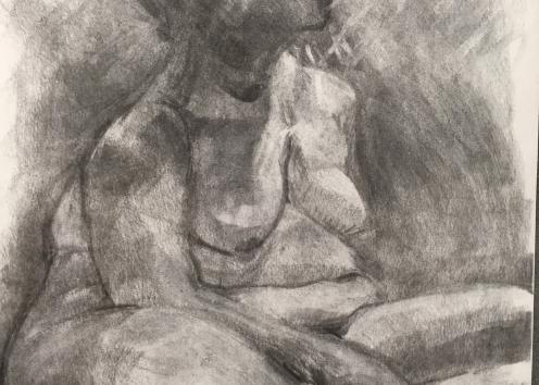 Charcoal drawing of a seated nude figure